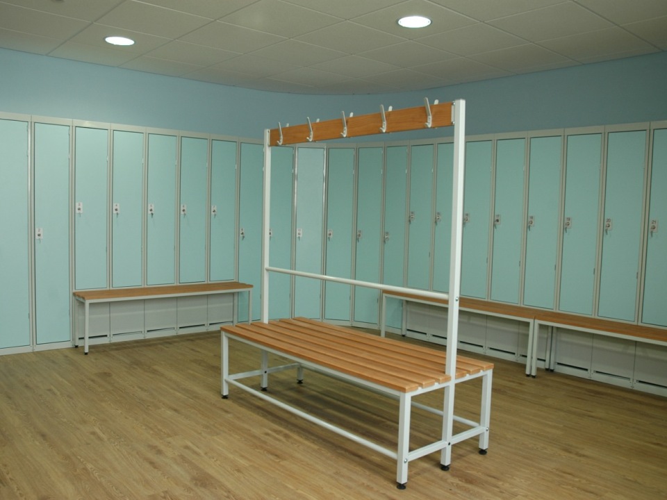 A wall of changing room lockers that curve round the corner