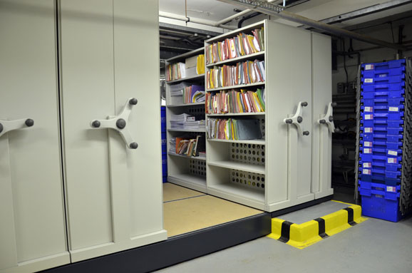 Movable shelves for compact filing