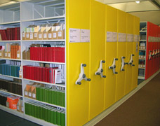 Colourful mobile shelving bays 