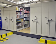 Movable shelving units that bridge a floor gap