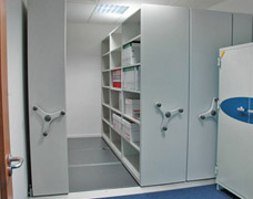 Compact roller shelving in small office corner