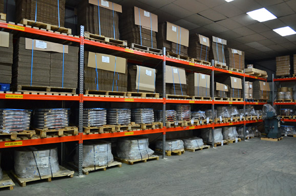 Pallets of cardboard boxes stored on racking