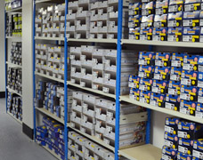 Shoe Boxes Stacked On Shelves In A Stockroom