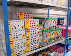 A variety of toys being stored on wire shelves Wire shelves for retail toy storage